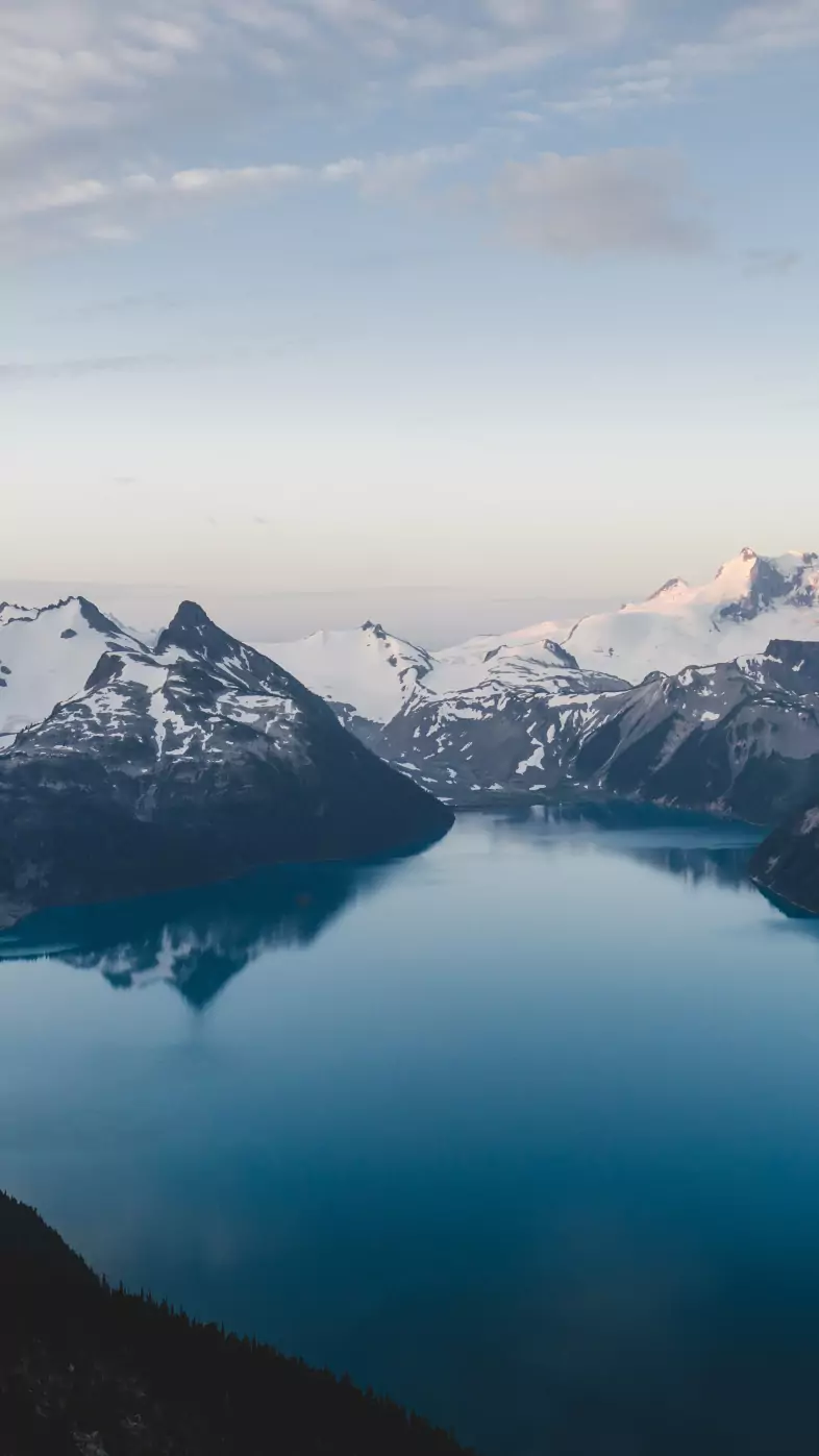 snow caped mountains under blue sky wallpaper