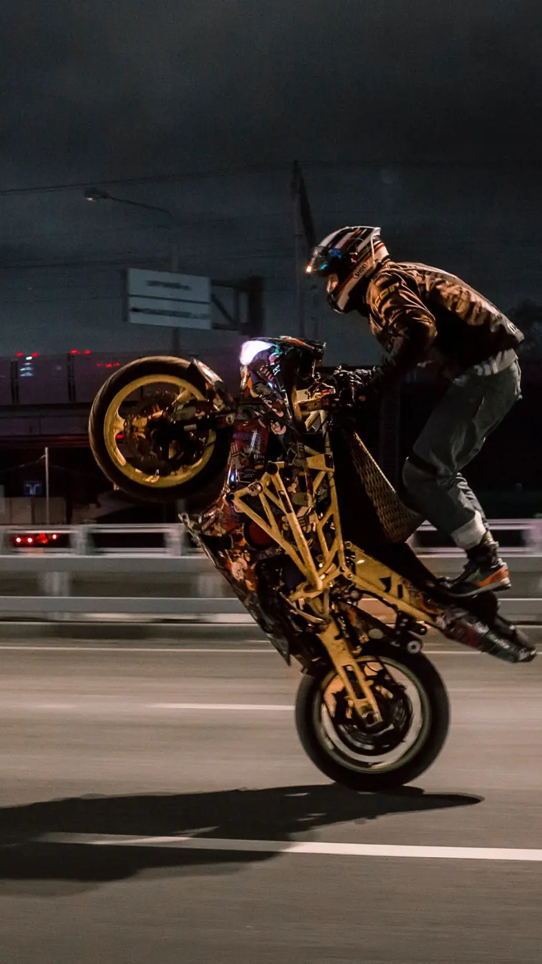 urban biker doing wheelie wallpaper